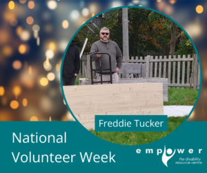 Photo of Freddie Tucker behind a garden box in the Empower accessible garden. There are white party lights behind. Title reads National Volunteer Week. The Empower logo is in the lower right corner.