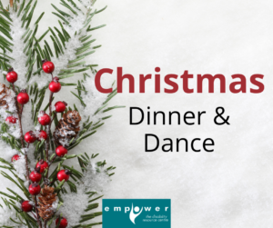 On a background of white snow, there is an evergreen branch with red berries and pinecones on the left. Title reads Christmas Dinner and Dance. The Empower logo is centered at the bottom.