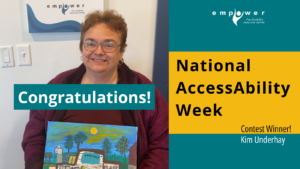 Kim Underhay poses with her painting of EmpowerNL. Text reads National AccessAbility Week Contest Winner Kim Underhay - Congratulations! The EmpowerNL logo is in the upper right corner.
