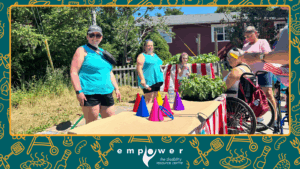 Empower N L staff Nina and Amanda run games for the members in our backyard carnival. The Empower N L logo is centered at the bottom.