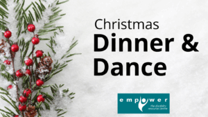 On the left are pine branches with red berries. Text reads Christmas Dinner & Dance. The Empower N L logo is centered below.